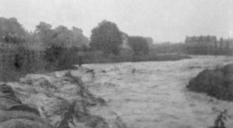 Beck in flood.jpg - The Beck at Bridge End after the flood of 20th July 1920.